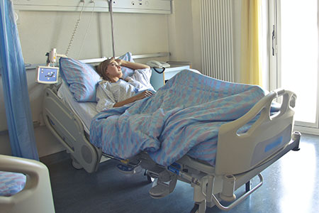 Hospital patient in bed waiting